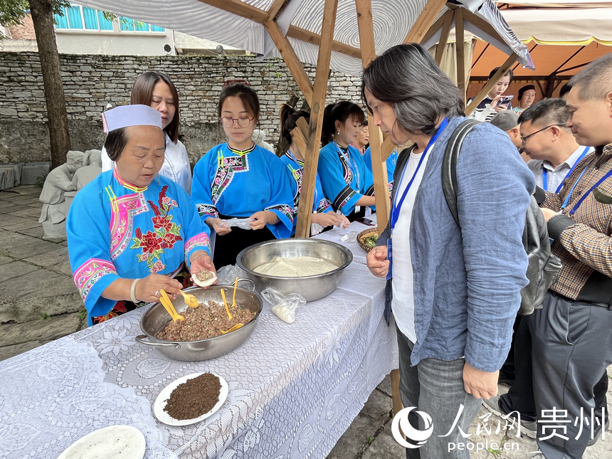 游客體驗(yàn)屯堡寨子美食。人民網(wǎng) 陳潔泉攝