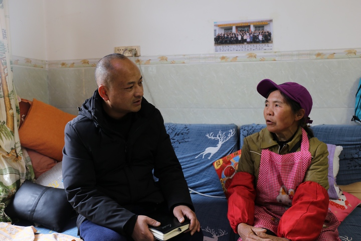 周榮在走訪村民。楊佩濤攝