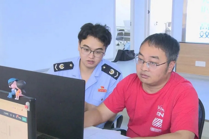 圖為“枝己”稅費服務志愿者上門輔導納稅人（張群攝）