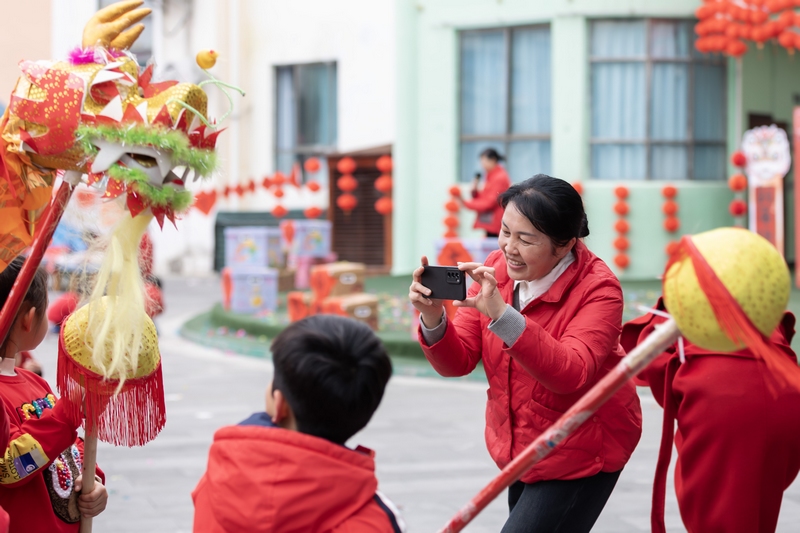 5 12月31日，在貴州省黔南布依族苗族自治州羅甸縣蓮花幼兒園開展的迎新年活動中，老師在給小朋友在拍照。 