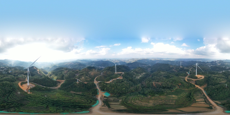已經投入使用的風力發(fā)電機正在不停轉動掃風。