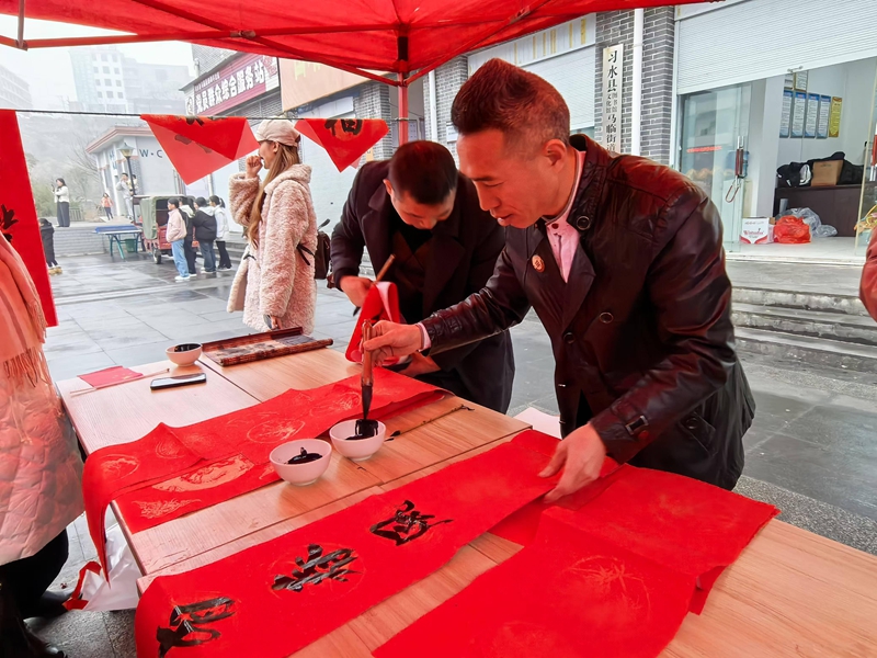 書(shū)法愛(ài)好者書(shū)寫(xiě)現(xiàn)場(chǎng)書(shū)寫(xiě)春聯(lián)（習(xí)水縣融媒體中心供圖）.jpg
