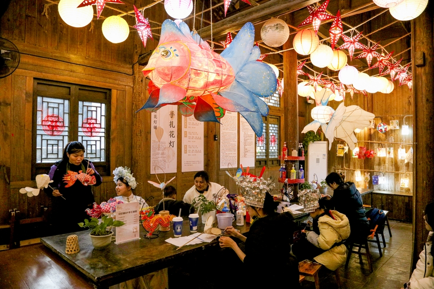 2月4日，游客在遵義市播州區(qū)烏江寨景區(qū)體驗制作非遺燈飾產(chǎn)品。