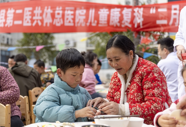 2025年2月28日，貴州省黔東南苗族侗族自治州施秉縣第二醫(yī)共體總醫(yī)院兒童康復(fù)科，家長(zhǎng)在指導(dǎo)孩子包餃子。（磨桂賓 攝）.jpg