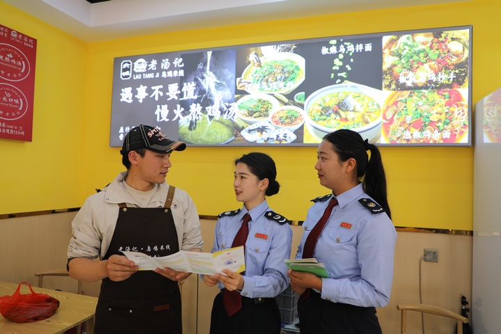 4 圖為普安縣稅務(wù)局“文旅服務(wù)專班”到景區(qū)周邊商超、餐飲等個體工商戶征詢涉稅服務(wù)需求，宣傳稅收優(yōu)惠政策。張杉 攝.JPG