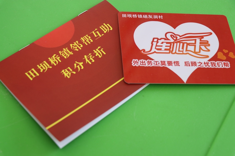 田壩橋鎮(zhèn)硝灰洞村“鄰幫互助積分存折”與“連心卡。劉娟攝