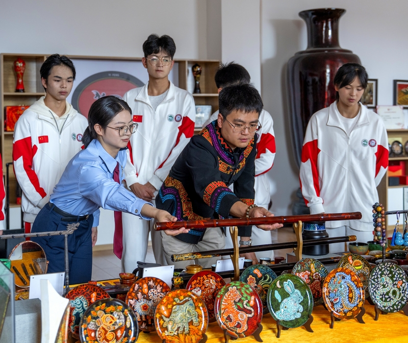 在大方縣高光彝風漆器開發(fā)有限公司，非遺傳承人員向稅務人員與學生介紹大方漆器的制作工藝與特點。聶燕云
